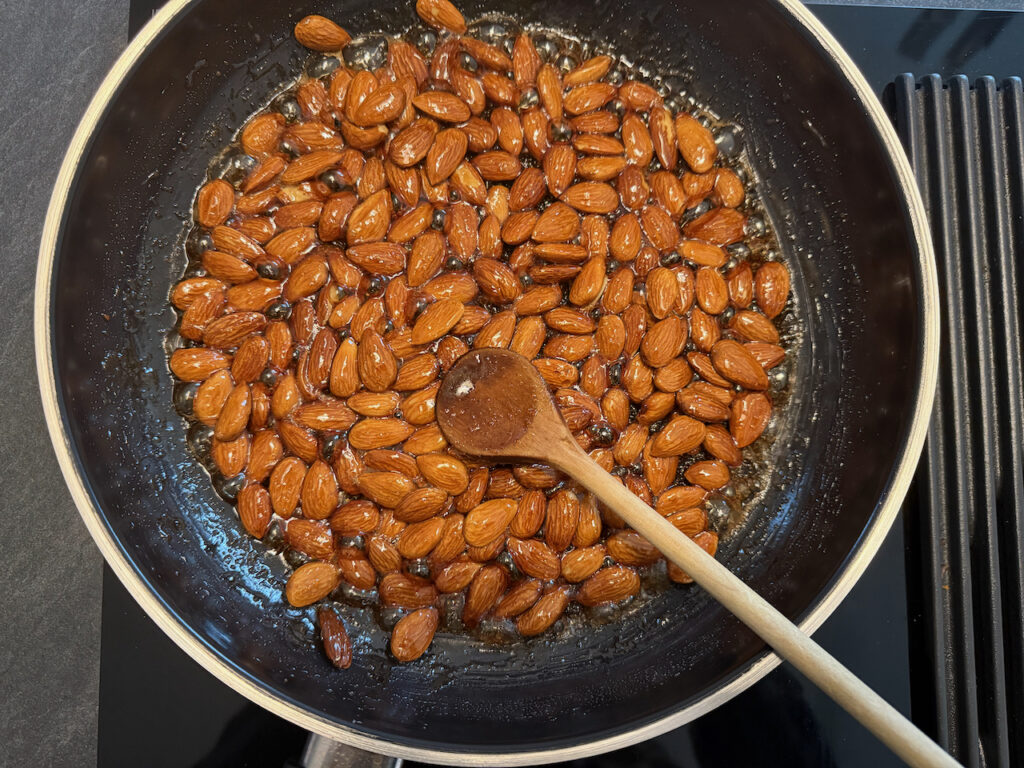Mandeln mit Wasser und Zucker in eine Pfanne geben